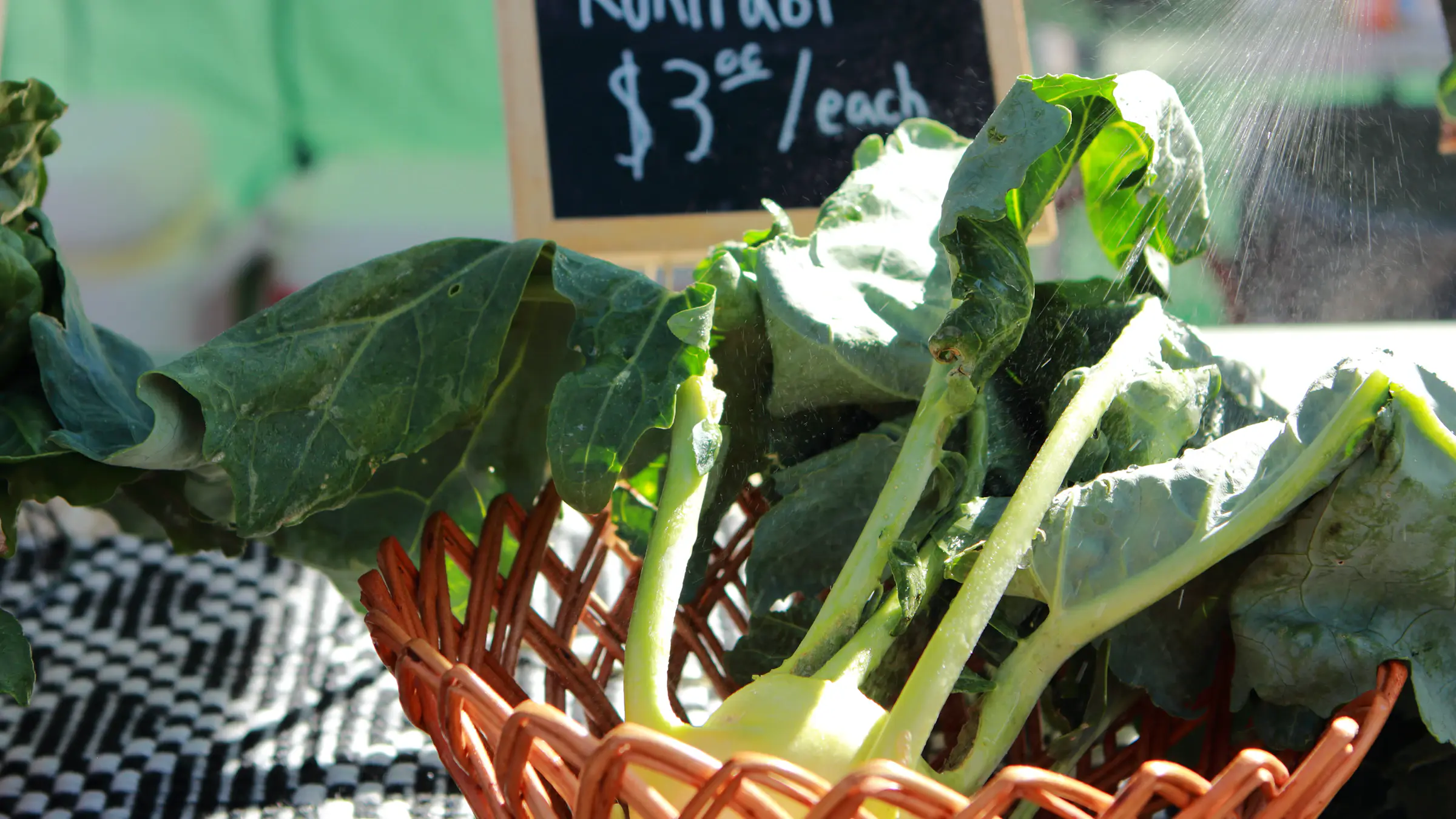Fresh kohlrabi bulbs with leaves at a farmer's market